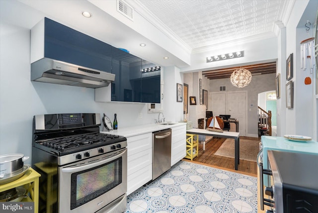 kitchen with a chandelier, stainless steel appliances, crown molding, white cabinets, and sink