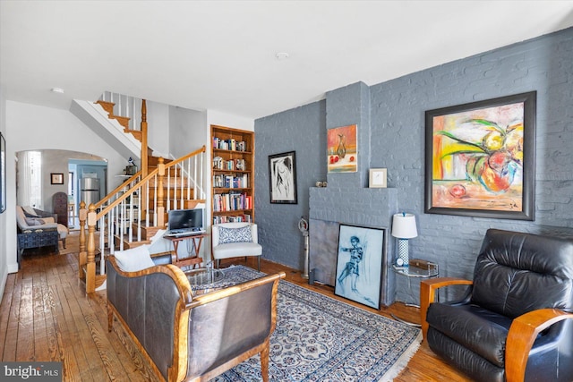 living room with hardwood / wood-style floors and built in features