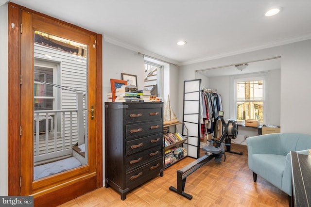 living area with ornamental molding and light parquet floors