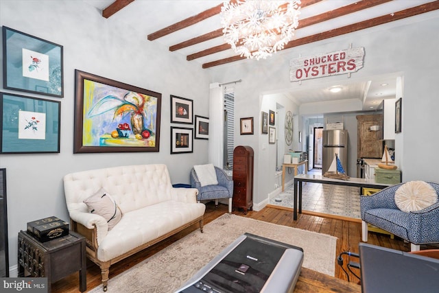 living room featuring beamed ceiling, a chandelier, and hardwood / wood-style floors