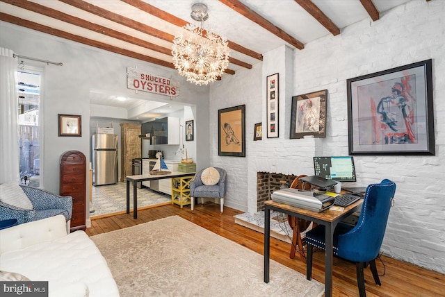 office space with crown molding, hardwood / wood-style flooring, a notable chandelier, and beam ceiling