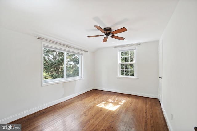 spare room with vaulted ceiling, ceiling fan, and hardwood / wood-style flooring