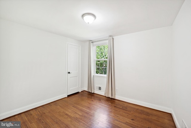 spare room with wood-type flooring