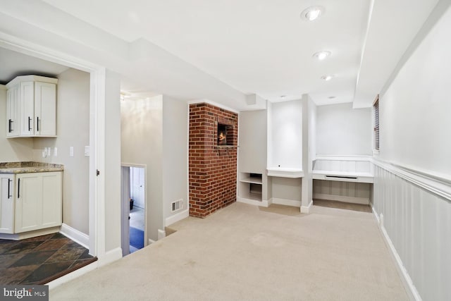 interior space featuring a fireplace and light colored carpet