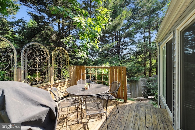 wooden terrace featuring a grill