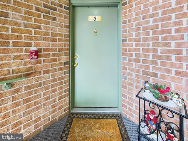 property entrance with brick siding