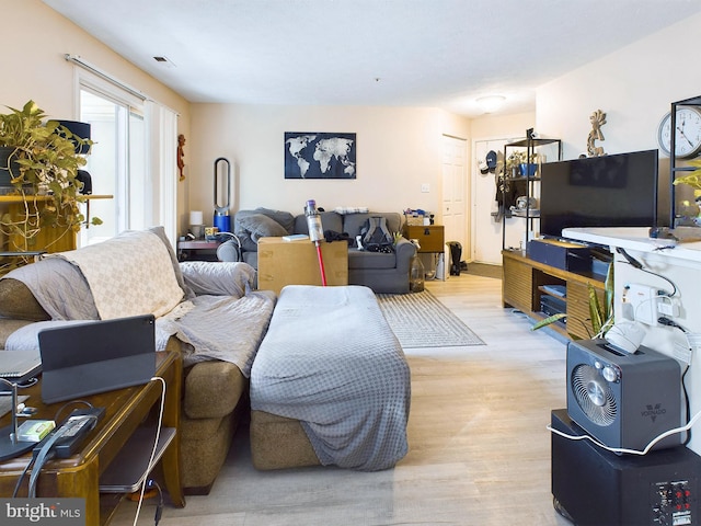 living room featuring visible vents and light wood-style flooring