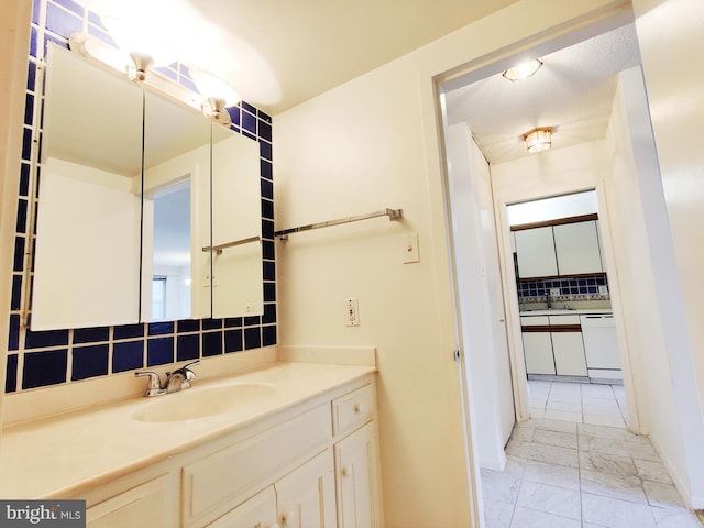 bathroom featuring vanity and decorative backsplash