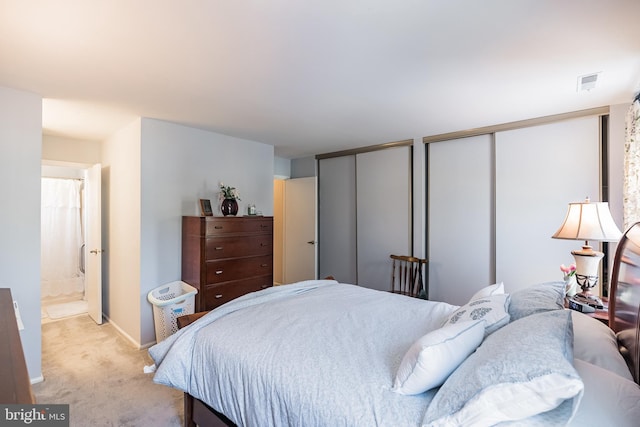 carpeted bedroom featuring two closets