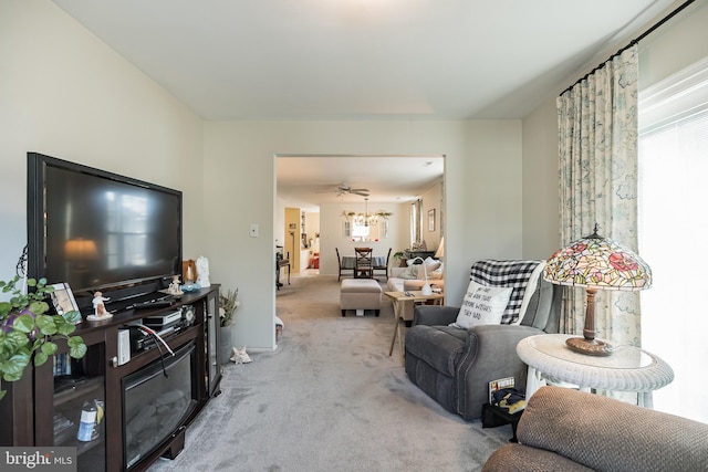 carpeted living room featuring ceiling fan