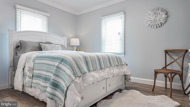 bedroom featuring dark hardwood / wood-style flooring, multiple windows, and crown molding