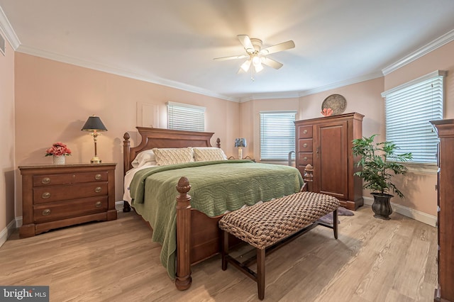 bedroom featuring ceiling fan, light wood-type flooring, and crown molding