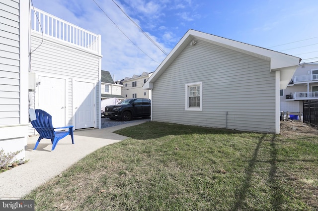 view of side of property with a lawn