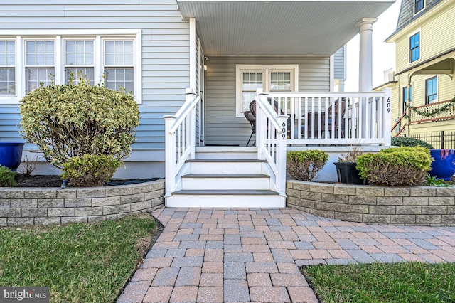 view of exterior entry with a porch