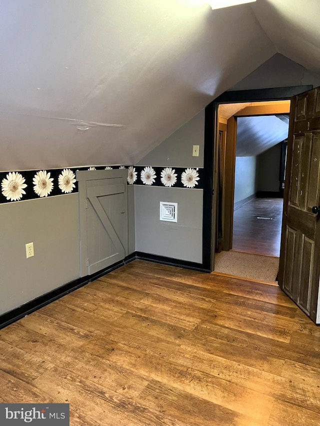 bonus room featuring hardwood / wood-style floors and lofted ceiling