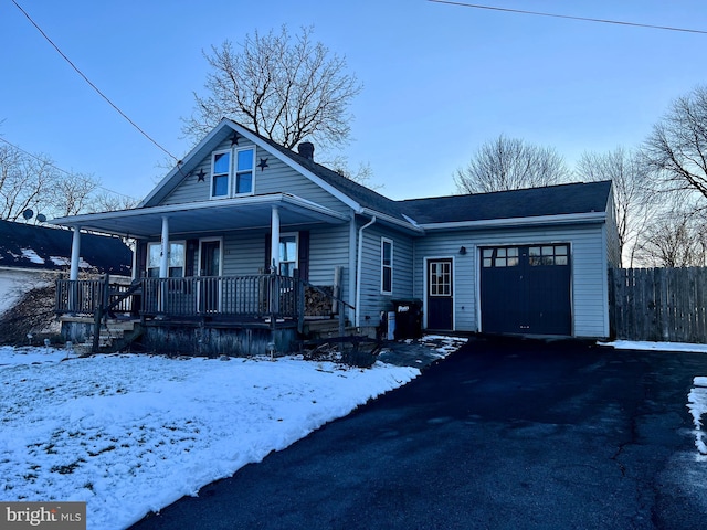 view of front of home featuring a porch and a garage