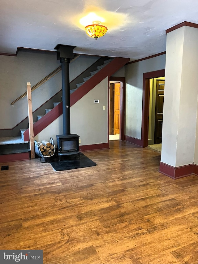 unfurnished living room with hardwood / wood-style flooring and ornamental molding