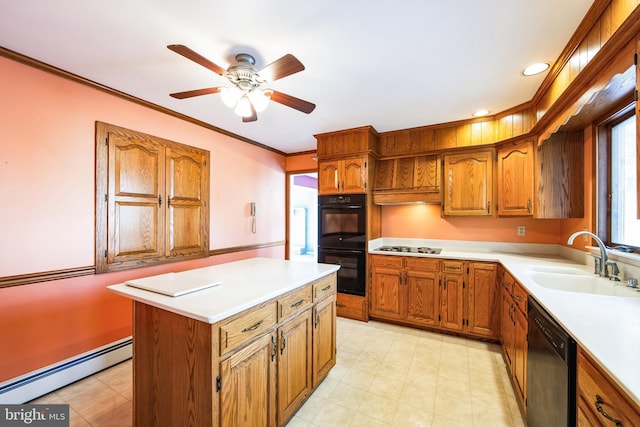 kitchen with a center island, black appliances, a baseboard heating unit, ceiling fan, and sink