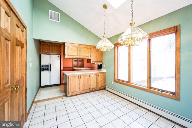 kitchen featuring white refrigerator with ice dispenser, kitchen peninsula, a notable chandelier, pendant lighting, and a baseboard radiator