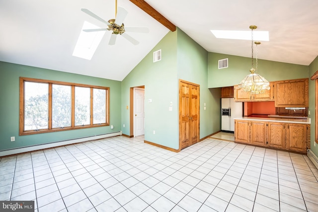 kitchen with white refrigerator with ice dispenser, hanging light fixtures, a skylight, ceiling fan with notable chandelier, and beamed ceiling