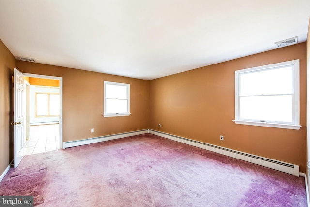 unfurnished room featuring baseboard heating and carpet flooring