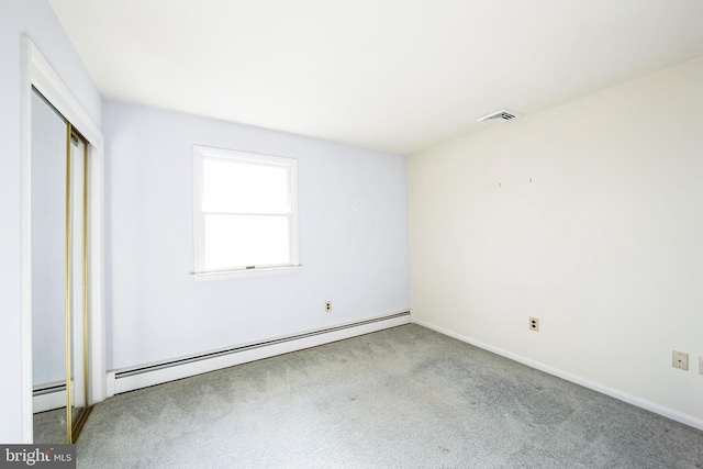 unfurnished bedroom featuring a baseboard heating unit and light carpet