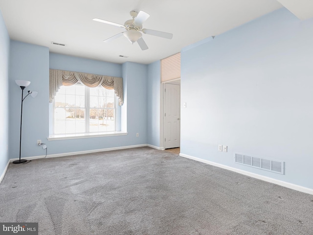 carpeted spare room with ceiling fan