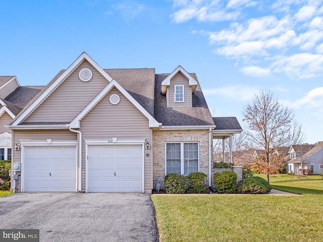 view of front facade with a garage and a front lawn