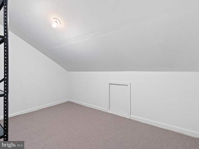 bonus room with carpet floors and vaulted ceiling