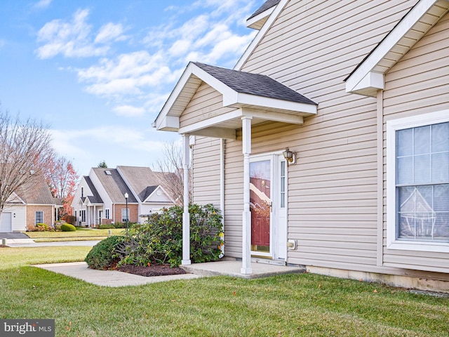 view of exterior entry with a yard