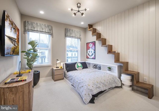 carpeted bedroom with wooden walls