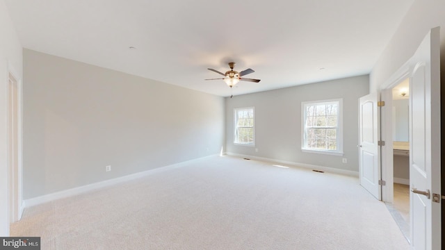 unfurnished bedroom featuring light carpet and ceiling fan