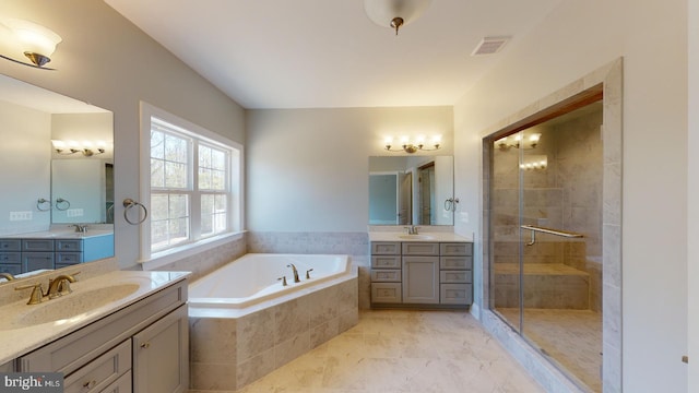 bathroom with vanity and independent shower and bath