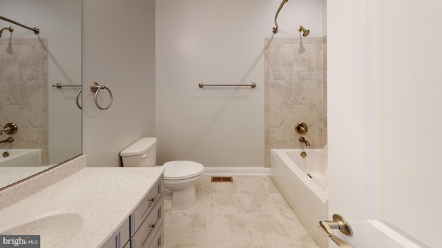 full bathroom featuring vanity, tiled shower / bath combo, and toilet