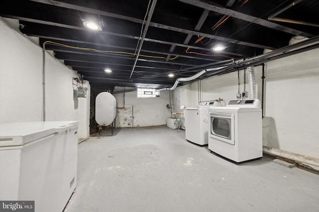 basement with washer and dryer and fridge