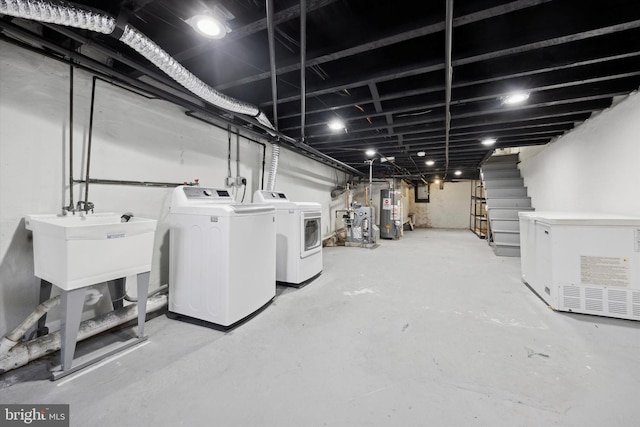 washroom featuring gas water heater and washer and clothes dryer