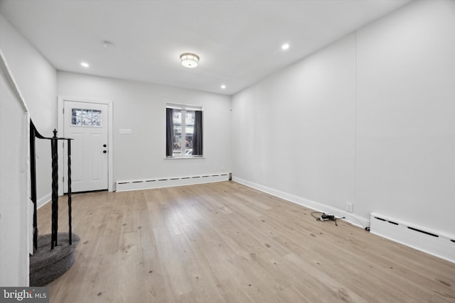 entrance foyer with light wood-type flooring and a baseboard radiator