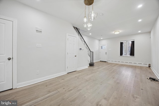 interior space featuring light wood-type flooring and a baseboard heating unit