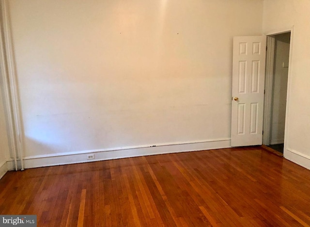 empty room with hardwood / wood-style floors