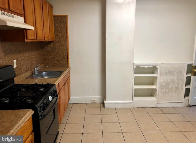 kitchen with sink, light tile patterned flooring, backsplash, and gas stove