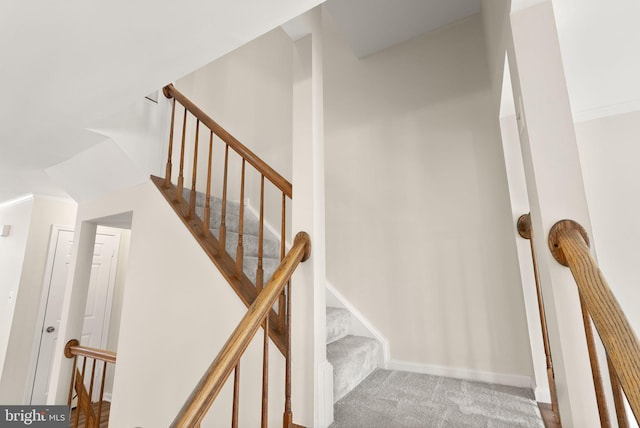 stairs with carpet floors and lofted ceiling