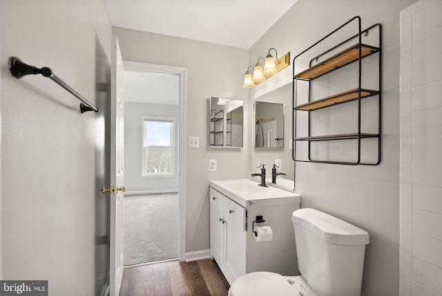 bathroom with vanity, hardwood / wood-style flooring, and toilet