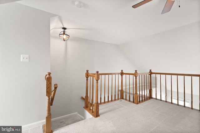 interior space featuring carpet floors, ceiling fan, and lofted ceiling