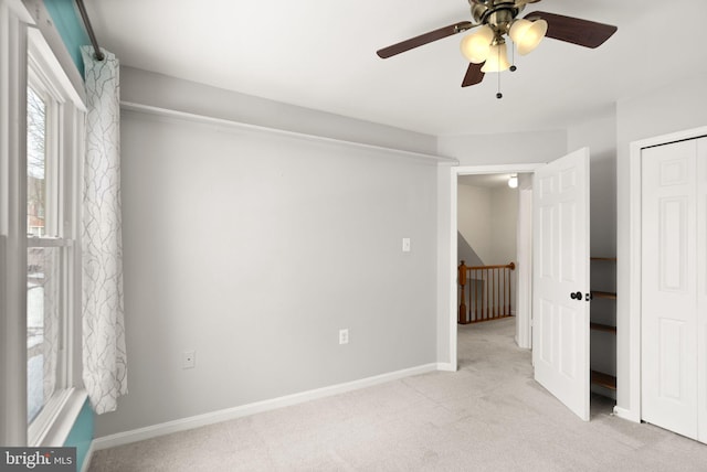 unfurnished room featuring ceiling fan and light colored carpet