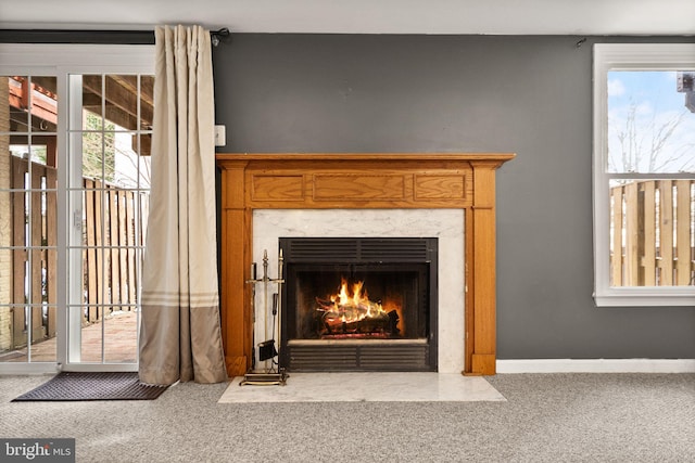 interior details with carpet floors and a fireplace