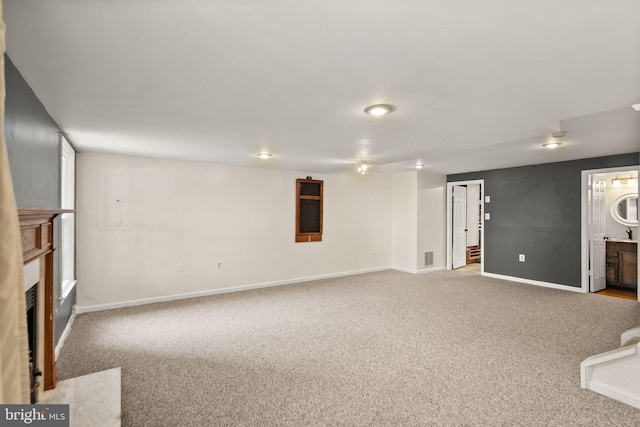 basement featuring light carpet