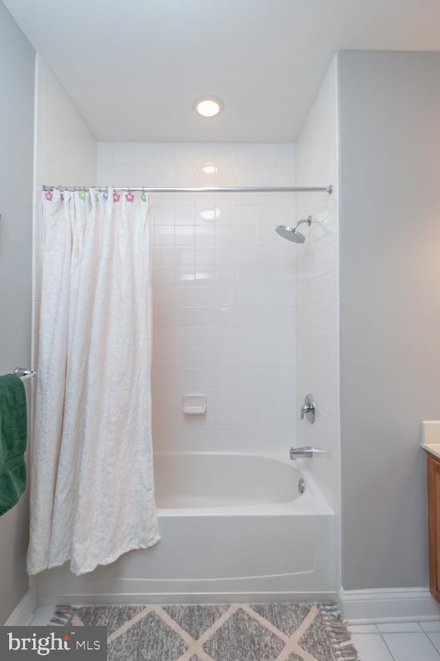 bathroom featuring tile patterned flooring, vanity, and shower / bath combo