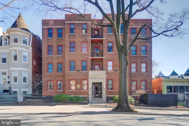 view of building exterior with fence