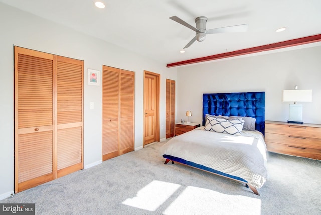 bedroom with baseboards, a ceiling fan, carpet floors, multiple closets, and recessed lighting