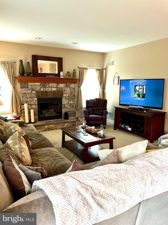 carpeted living room with a fireplace